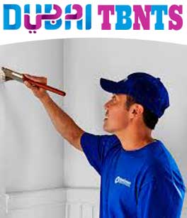 Man paint wall with brush-Painting services Dubai